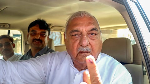 Haryana Assembly Leader of Opposition Bhupinder Singh Hooda shows his ink-marked finger after casting his vote during Haryana Assembly elections.