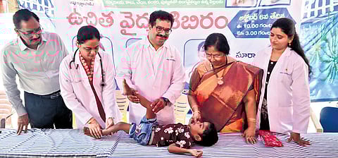 Peadiatric Orthopedic Surgeon Dr K Durga Nagaraju checks a boy with Cerebral Palsy during a medical camp held at Anu Hospital on Sunday 