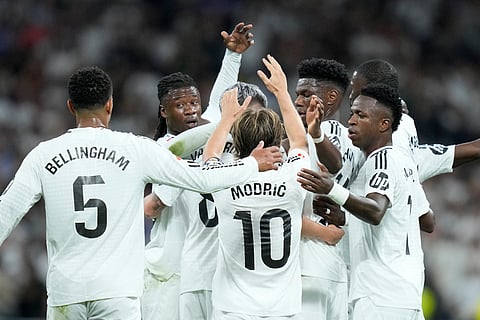 Real Madrid players celebrate after a goal during the La Liga soccer match between Real Madrid and Villareal in Madrid, Spain, on Saturday.
