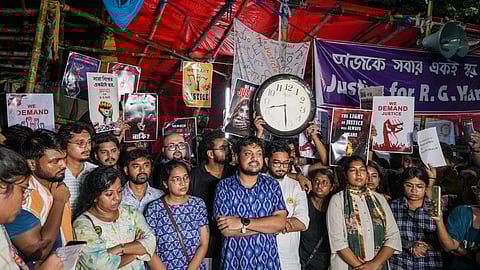 Junior doctors stage a protest against the alleged rape and murder of their colleague at the RG Kar hospital at their sit-in site, in Kolkata.