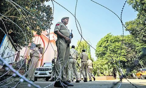 Security personnel stand outside a counting centre in Jammu, a day before the counting of votes for Jammu & Kashmir Assembly polls on Monday.