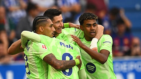 Barcelona's Robert Lewandowski, center, celebrates after scoring his side's 2nd goal against Alaves during a Spanish La Liga soccer match at the Mendizorroza stadium in Vitoria-Gasteiz, Spain.
