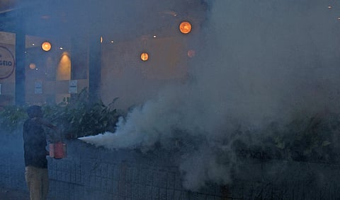 To control the mosquito menace, a worker does fogging at infantry in Bengaluru on Monday