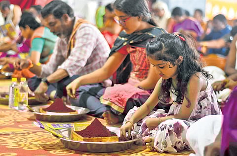 Devotees perform Kumkum pooja during Dussehra festivities atop Indrakeladri hill in Vijayawada on Tuesday.