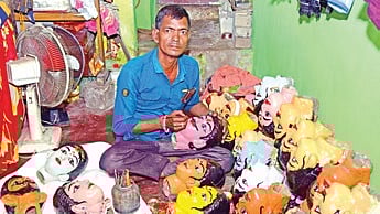 Puppeteer Ganesh Laha painting the puppets