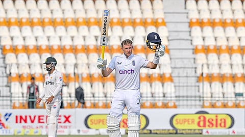 England's Joe Root (R) celebrates after scoring a century (100 runs) during the third day of the first Test cricket match between Pakistan and England at the Multan Cricket Stadium in Multan.