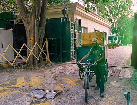 A worker carrying goods on a cart leaves from 6, Flagstaff Road in Civil Lines, the official residence of Chief Minister of Delhi, in New Delhi, Wednesday, Oct. 9, 2024