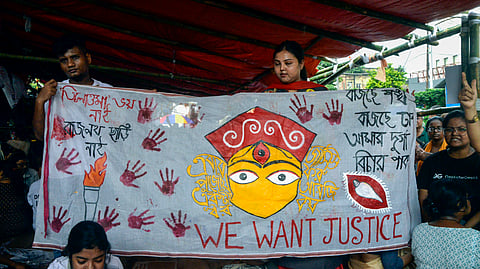 People hold a banner during the Junior Doctors fast-unto-death hunger strike demanding justice for the victim of the RG Kar Hospital rape-murder case, in Kolkata on Wednesday, Oct. 9, 2024.