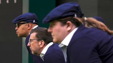 Line judges concentrate during a men's singles match at the Wimbledon tennis championships in London