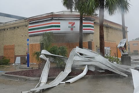 An apparent tornado caused by Hurricane Milton, tore the awning off a 7-Eleven convenient store, Wednesday, Oct. 9, 2024, in Cape Coral, Fla.