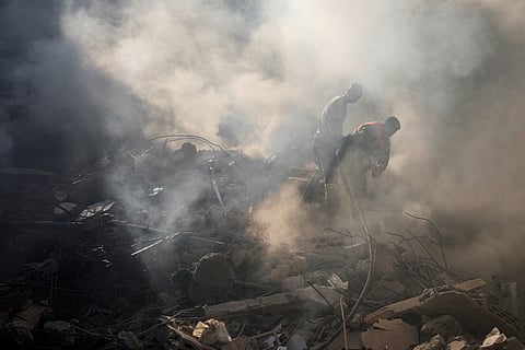 Rescue workers search for victims at the site of Thursday's Israeli airstrike in Beirut, Lebanon, Friday, Oct. 11, 2024.