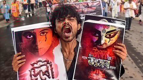  A man raises slogans while holding placards during a protest rally by doctors, nursing staff and others towards the CBI office against the alleged rape and murder of a woman medic at the RG Kar Medical Collage and Hospital, in Kolkata, Wednesday.