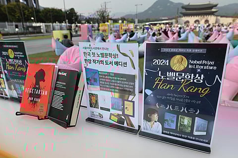 Books by South Korean author Han Kang, who won the 2024 Nobel Prize in Literature, are displayed during an outdoor library event at Gwanghwamun square in central Seoul on October 11, 2024.