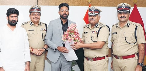 Indian cricketer Mohammed Siraj with DGP Jitender in Hyderabad on Friday.