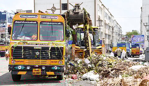 Sanitation workers collecting waste from EB road in Tiruchy on Saturday
