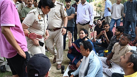 A policeman speaks with climate activist Sonam Wangchuk staging a protest demanding the inclusion of Ladakh in the Sixth Schedule of the Indian constitution.