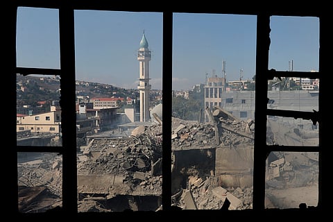 Destroyed buildings at a commercial street that was hit Saturday night by Israeli airstrikes, are seen in Nabatiyeh town, south Lebanon, Sunday, Oct. 13, 2024.