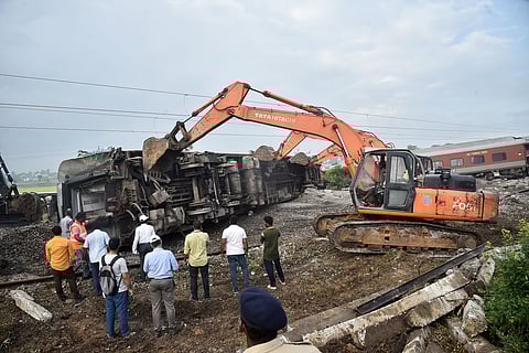 Indian railway workers and TNDRF restoring the site by pushing the coaches off the trackof the Mysuru-Darbhanga Bagmati Express train derailed after ramming into the rear of a goods train at the Kavaraipettai Railway Station.