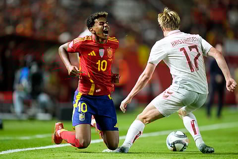 Spain's Lamine Yamal, left, and Denmark's Victor Kristiansen battle for the ball during the UEFA Nations League group 4 soccer match between Spain and Denmark in Murcia, Spain, Saturday, Oct. 12, 2024