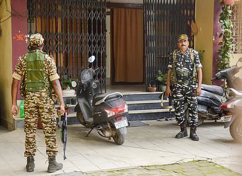  CRPF personnel stand outside the residence of Manish Ranjan, close aide of Jharkhand Minister Mithilesh Thakur, as the ED conducts raids in the connection with the alleged rural development scam, in Ranchi, 