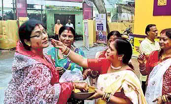 Bengali women applying vermilion on each other at Sahid Padia in Baripada.