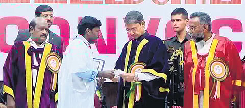 A Prakash submitting a petition to Governor RN Ravi during the convocation at Bharathiar University in Coimbatore on Monday 