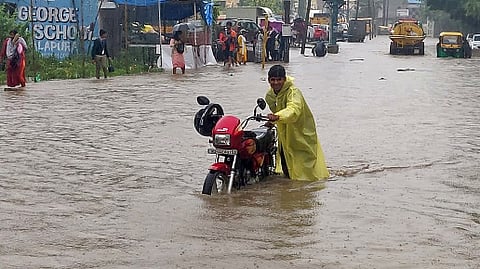 A biker wades through the flooded Hennur Bande-Horamavu Road in Bengaluru.