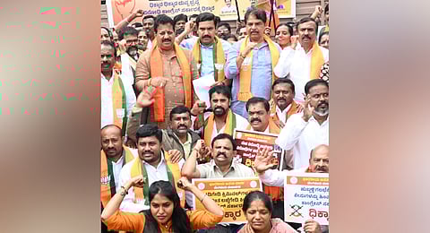 BJP leaders, including state party chief BY Vijayendra and LoP in Assembly R Ashoka, protest against the State Government’s decision to withdraw cases against those accused in the 2022 Hubballi riots, in Bengaluru on Monday 
