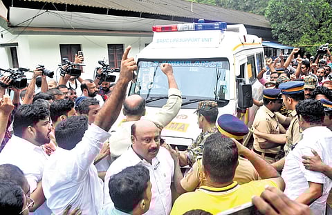 Members of various organisations protest as the body of Naveen Babu is shifted from Pallikunnu government quarters to a hospital in Kannur on Tuesday