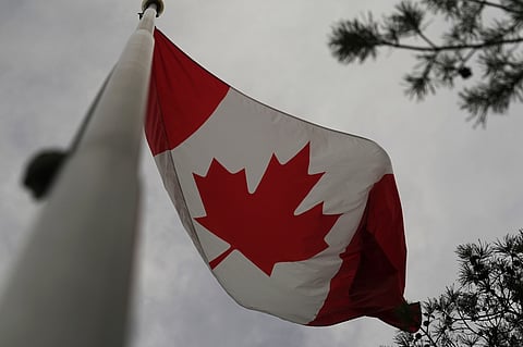 The Canadian flag is blown by wind on Centre Island in Toronto on Thursday, 