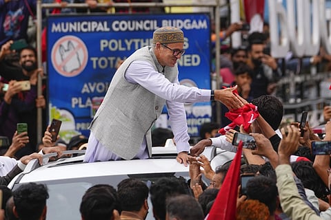 Jammu and Kashmir National Conference (JKNC) party leader Omar Abdullah, standing in car shakes hands with supporters as he celebrates his victory in the recently concluded election, Tuesday, Oct 8, 2024.