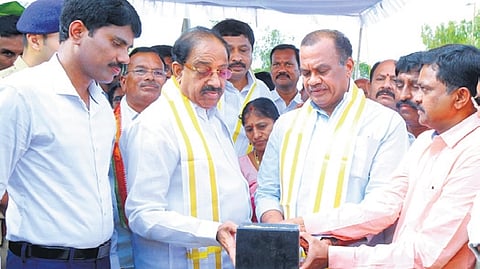 Ministers Thummala Nageshwara Rao and Komatireddy Venkat Reddy checking moisture in paddy at SLBC purchase centre in Nalgonda on Wednesday.