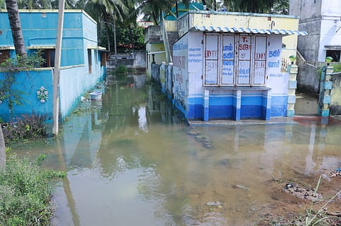 Many houses have been submerged in water and are filled with sand.