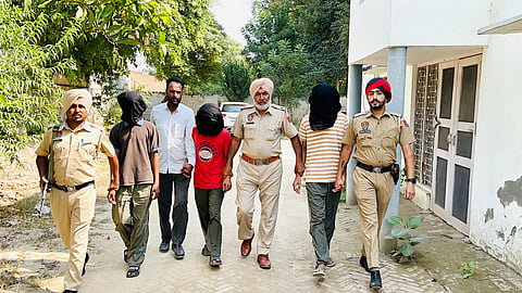 Punjab Police with the three arrested accused.