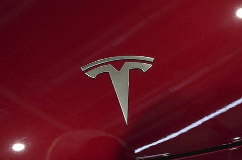 The logo of Tesla car is pictured at the Paris Auto Show, in Paris, Monday, Oct. 14, 2024.