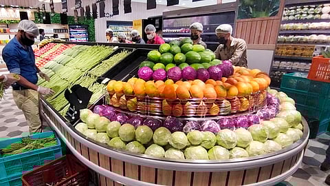 Workers arranging fruits and vegetables at a store in Thiruvananthapuram.