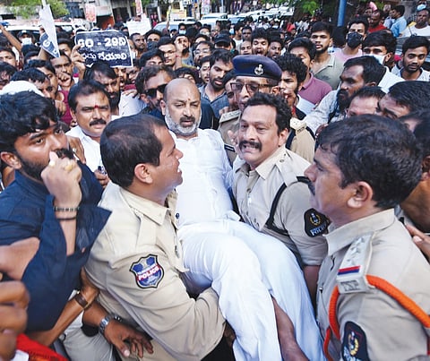 Police personnel take Minister of State for Home Affairs Bandi Sanjay into preventive custody as they disperse protesters taking part in a “Chalo Secretariat” rally  in Hyderabad on Saturday