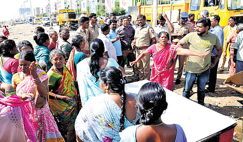 Residents of Nochikuppam engage in a heated exchange with corporation officials over the relocation of their fish stalls along the Marina Loop Road 
