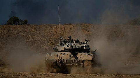An Israeli army tank maneuvers near the Israel-Gaza border in southern Israel, Sunday, Oct. 20, 2024.