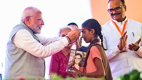 Prime Minister Narendra Modi felicitates a child during the inauguration ceremony of the RJ Sankara Eye Hospital, in Varanasi, Sunday.