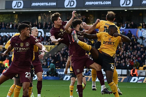 Manchester City's John Stones, top left, scores his side's 2nd goal during the English Premier League match between Wolverhampton Wanderers and Manchester City.