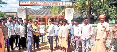 Parents handing over a memorandum to the headmaster of a school