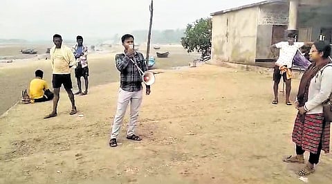 An official making announcement at Udaipur sea beach in Bhograi block