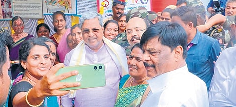 A woman takes a selfie with Chief Minister Siddaramaiah after the launch of several welfare works in Varuna constituency, in Mysuru on Tuesday