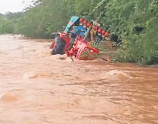 A tractor washed away in rain water at Gajjuganahalli village on Tuesday