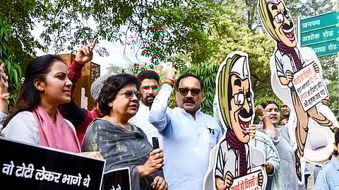 Delhi BJP President Virendra Sachdeva, along with party workers, stage a protest against AAP over alleged misuse of taxpayers' money in New Delhi on Tuesday. 