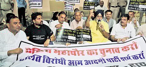 LoP in MCD House Raja Iqbal with others protesting at the civic centre in Delhi.