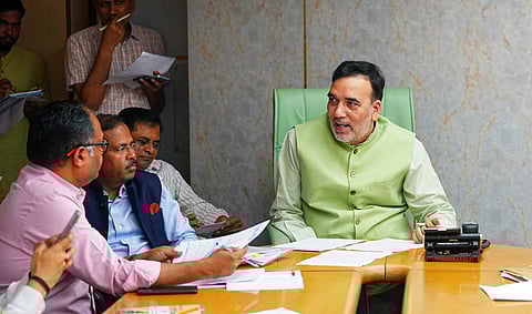 Anti-smog gun spraying water droplets near Parliament House.