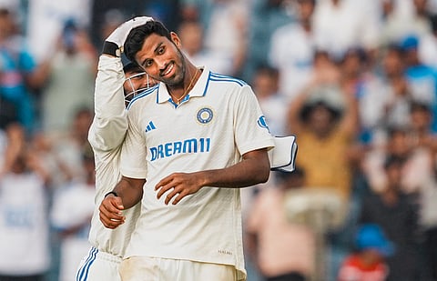 Washington Sundar and Rishabh Pant celebrate the wicket of New Zealand's Mitchell Santner during the first day of the second test cricket match between India and New Zealand.