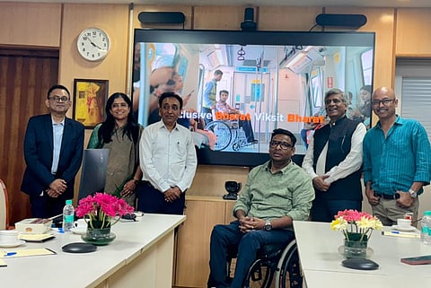 Entire members behind a display of film 'Inclusive Bharat, Viksit Bharat'.